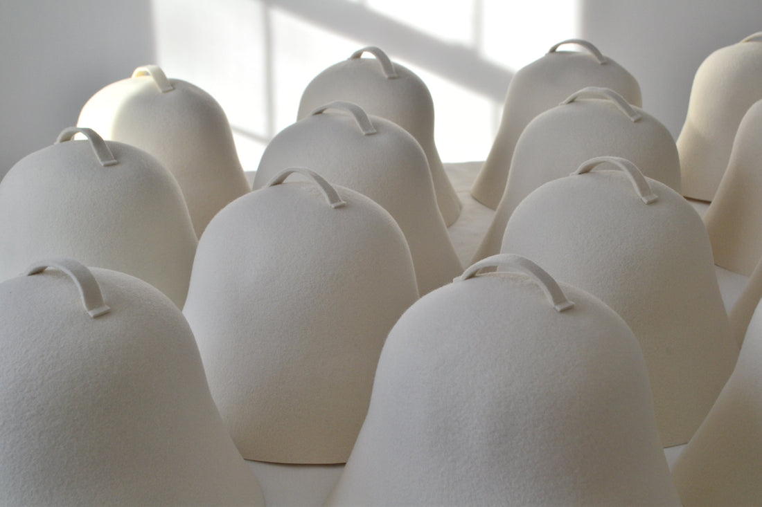 A serene view of NORDI wool sauna hats, representing the stress-reduction and mental health benefits of a regular heat therapy practice