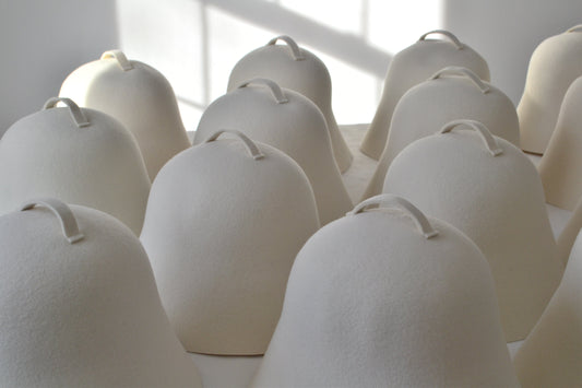 A serene view of NORDI wool sauna hats, representing the stress-reduction and mental health benefits of a regular heat therapy practice