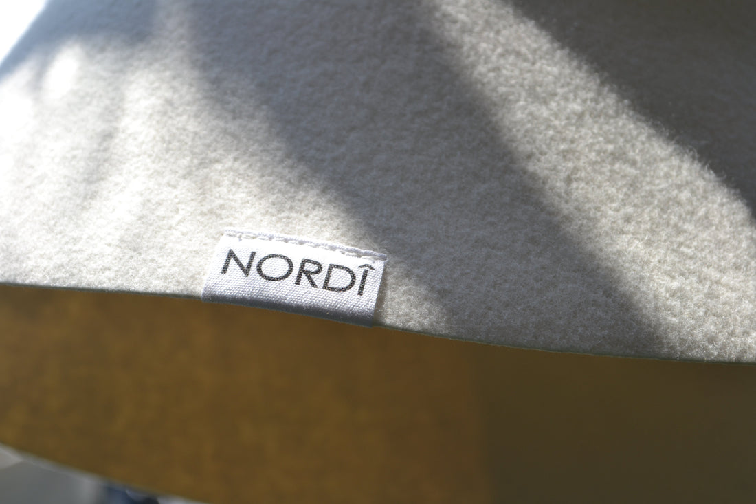 Handcrafted NORDI sauna hat in the sun light, perfect for head protection in both traditional and high-heat infrared saunas.